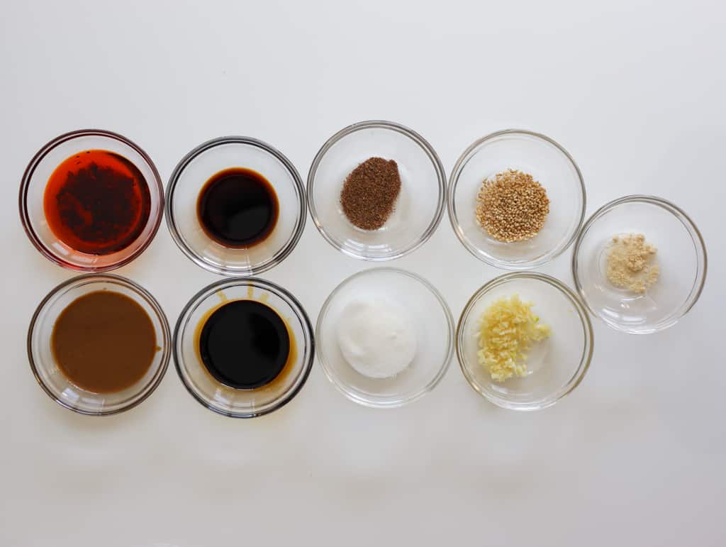 Ingredients for savory Dan Dan noodle sauce in small glass bowls.