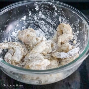 Then add cornstarch to seasoned shrimp and mix until each piece of shrimp is well coated.