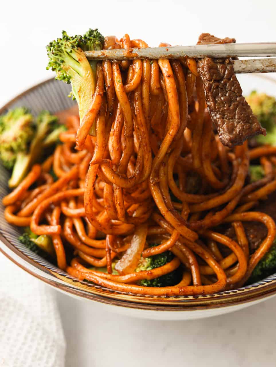 noodle pull shot of beef and broccoli noodles