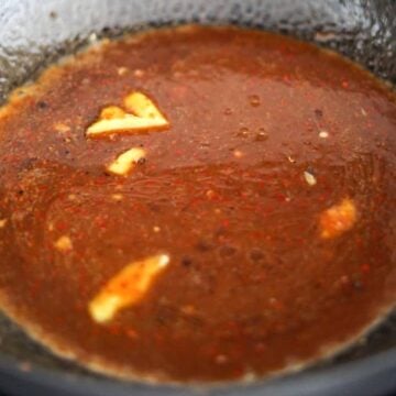 Pan with ginger and prepared sauce simmering until slightly thickened