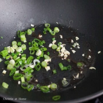 Reduce to low-medium heat and sauté garlic and green onions for 10 seconds or until fragrant.