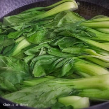 Bok choy blanching in boiling water until vibrant green and tender-crisp.