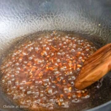 Garlic sauce simmering until glossy and thick enough to coat a spoon.