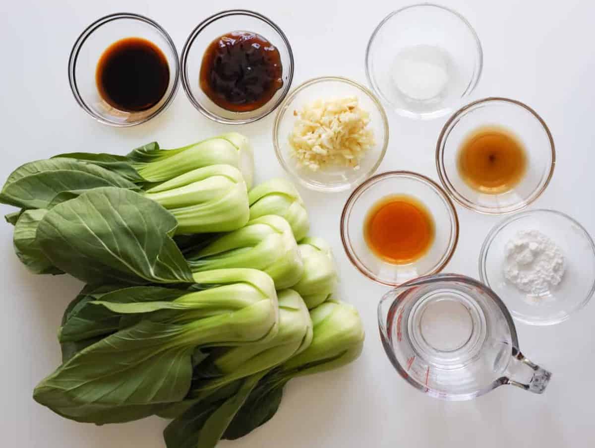 Bok choy, garlic cloves, oyster sauce, soy sauce, Shaoxing wine, toasted sesame oil, cornstarch, sugar, and water for Chinese garlic bok choy.