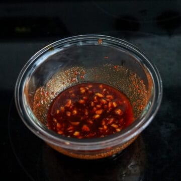Whisk mixing sauce ingredients in a bowl.