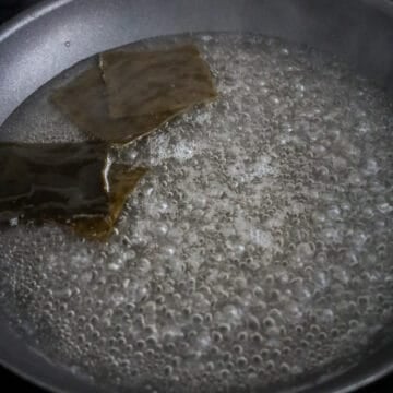 Kelp boiling in water inside a pan.