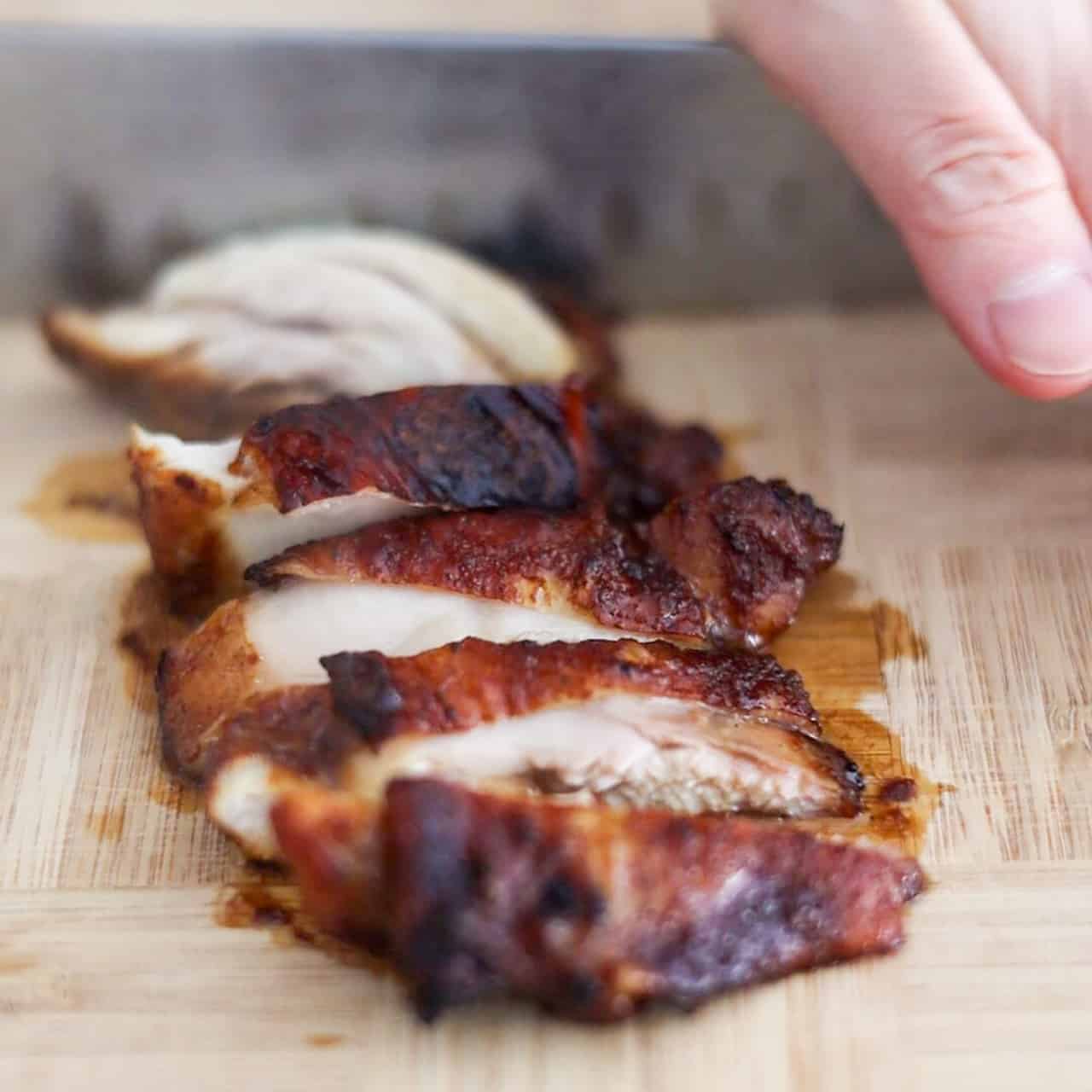 Air-fried soy sauce chicken with deeply caramelized skin sliced into even strips.