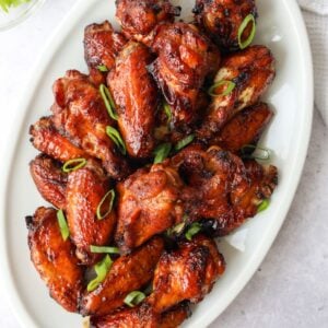 Air fryer soy sauce chicken wings garnished with green onions