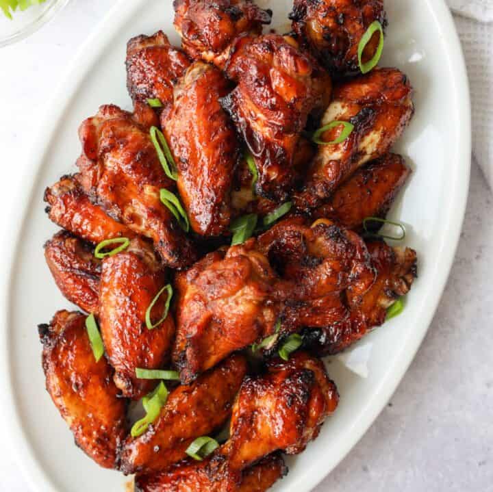 Air fryer soy sauce chicken wings garnished with green onions