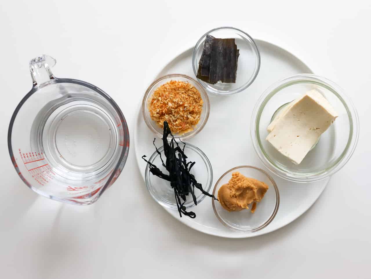 Dried kombu, bonito flakes, yellow miso paste, soft tofu, dried wakame seaweed, and cold water for making miso soup.