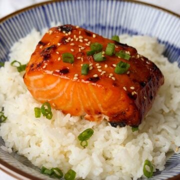 Teriyaki salmon garnished with green onions and sesame seeds