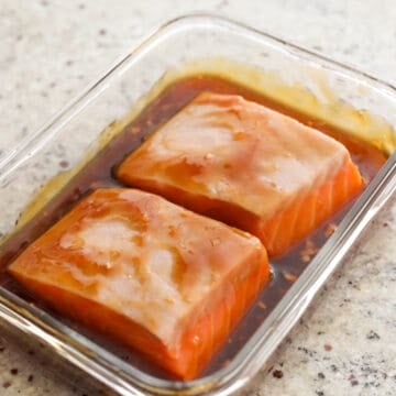 Raw salmon filets coated in teriyaki glaze
