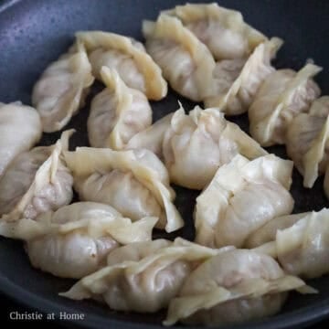Pan-fried pork dumplings with golden-brown crispy bottoms.