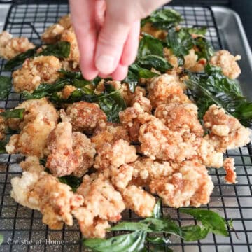 Crispy Taiwanese popcorn chicken topped with fried Thai basil leaves.