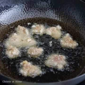 Golden Taiwanese popcorn chicken frying in bubbling hot oil.