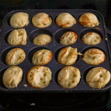 Poffertjes cooking until golden brown and fluffy.