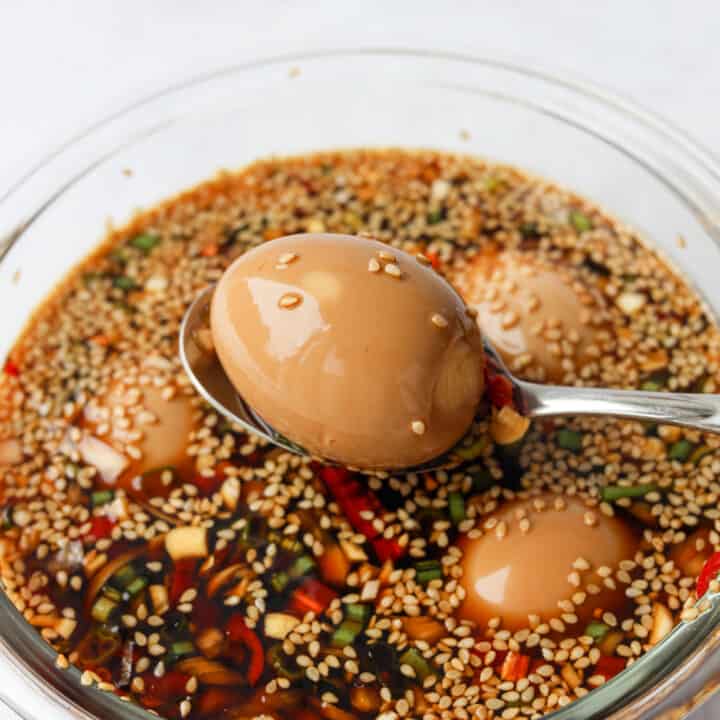 Peeled eggs soaking in Korean soy marinade.