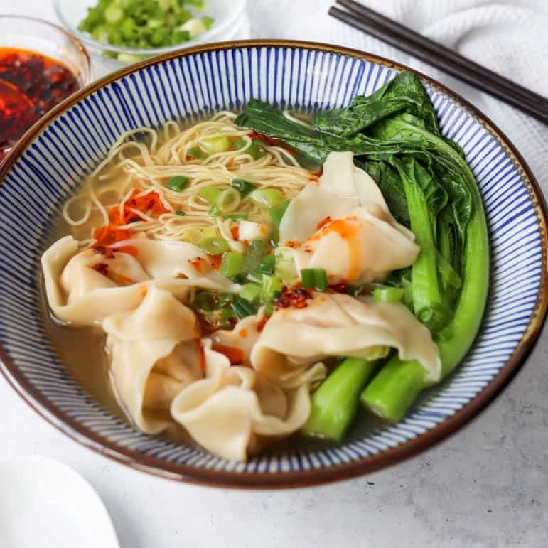 Place cooked wontons on top of noodles and pour hot wonton soup over top. Garnish with more green onions and optionally enjoy with chili oil.