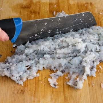Rinse peeled and deveined shrimp under cold water until it runs clear and strain out as much water as possible. Transfer shrimp to a cutting board and finely mince it with a large knife in a chopping motion until it becomes pasty. You may also use a food processor with a pulsing motion.