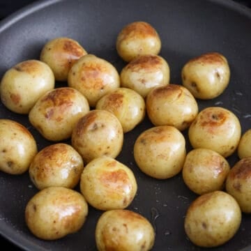 Heat vegetable oil in a large non-stick pan on medium heat. Fry strained baby potatoes for 2-4 minutes until slightly brown on both sides.