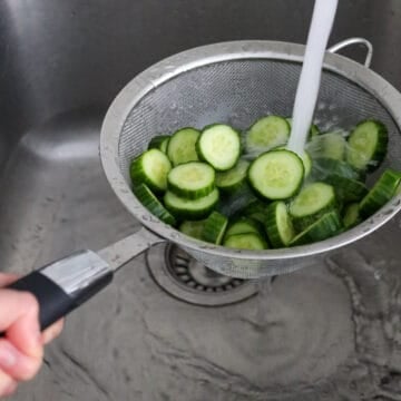 Rinse the cucumbers with running cold water to remove excess salt. Strain out as much excess water as possible.