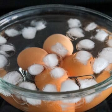 Boiled eggs cooling in ice water.