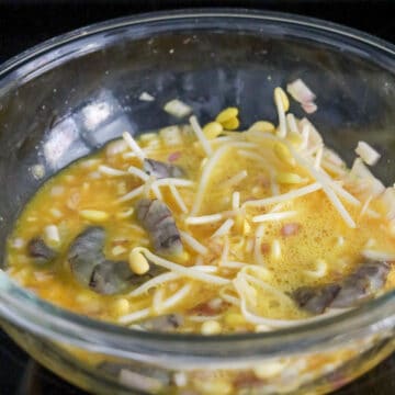 Beaten eggs mixed with raw shrimp, bean sprouts, and shallots.