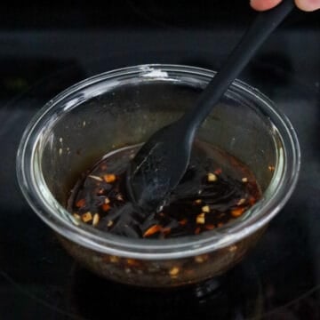 Dark brown savory stir-fry sauce mixed in a glass bowl.