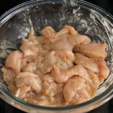 Sliced chicken breast coated in soy sauce marinade.
