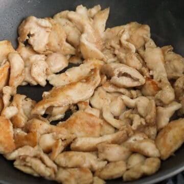 Chicken slices pan-fried until lightly golden on both sides.