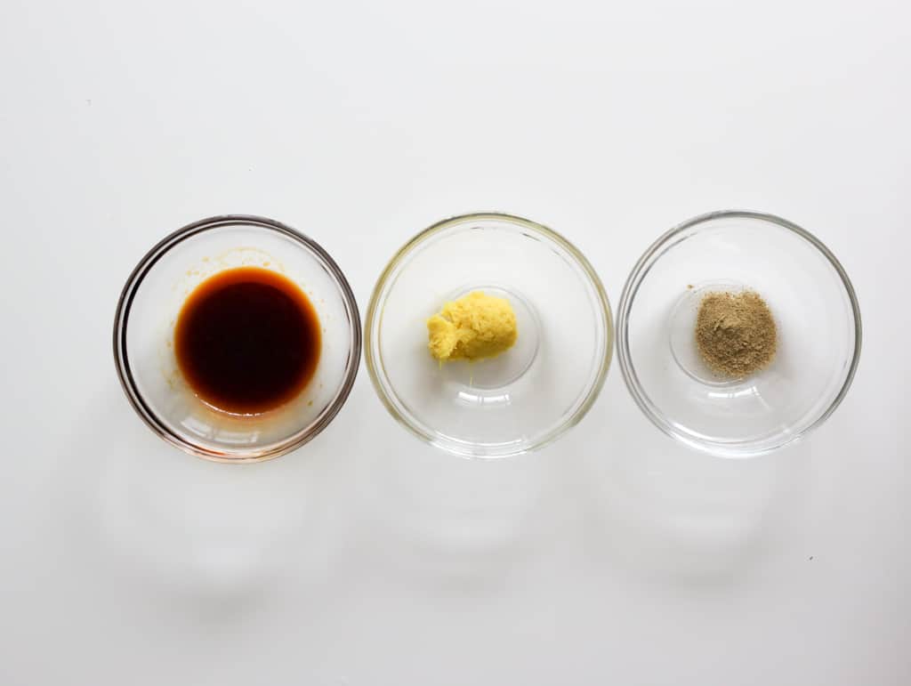 Soy sauce, fresh ginger, and white pepper for crispy ginger chicken.