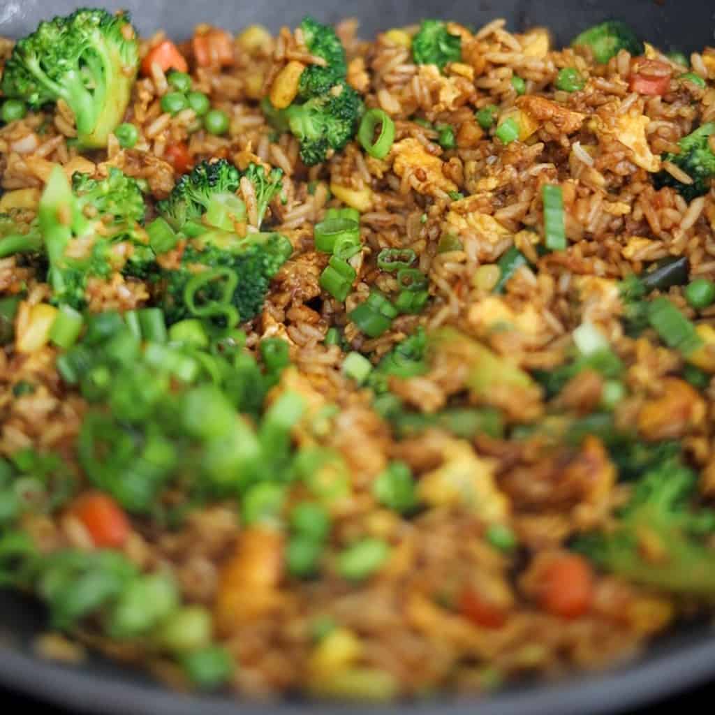 Add rice with seasoning ingredients and toss until coated. Garnish with green onions.