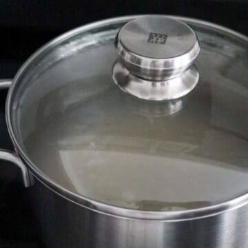 White tapioca pearls boiling in a pot of water.