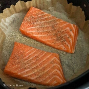 To air fry: Line the air fryer basket with air fryer parchment paper or aluminum foil. Place the salmon filets skin side down in a single layer without overlap. Evenly season the salmon with salt, black pepper and garlic powder.Â