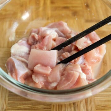 Dice chicken thighs into 1-inch cubes. Transfer chicken pieces into a small bowl and mix in sake.
