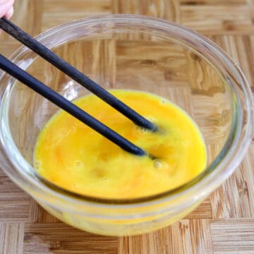 crack eggs and lightly beat 65% of the way until the yolks come together