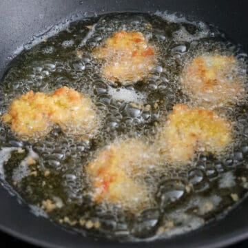 Panko shrimp frying in hot oil until golden and crispy
