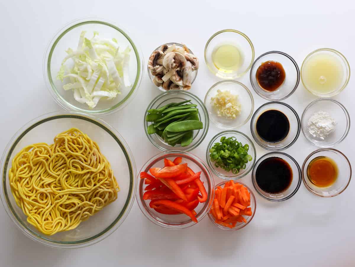Fresh lo mein noodles, red bell pepper, snow peas, napa cabbage, carrots, mushrooms, green onions, garlic, soy sauces, oyster sauce, sesame oil, chicken stock, cornstarch, and sesame seeds.