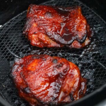 Air fry for 9-10 minutes in total at 375 degrees F. No flipping needed. Cook until an internal temperature of 165F with a digital instant read thermometer inserted into the thickest part of the chicken thigh or until juices run clear.