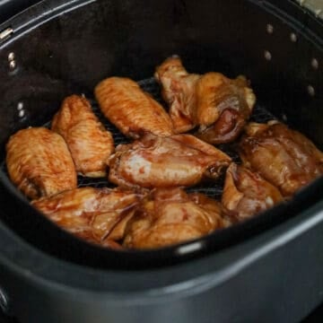 Marinated chicken wings arranged in the air fryer