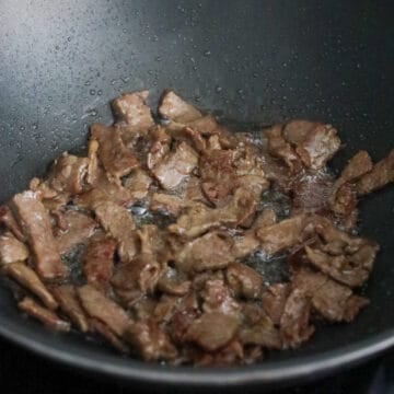Heat vegetable oil in a large pan on medium-high heat. Fry marinated beef in a single layer until cooked and slightly browned on edges. Remove and set aside.