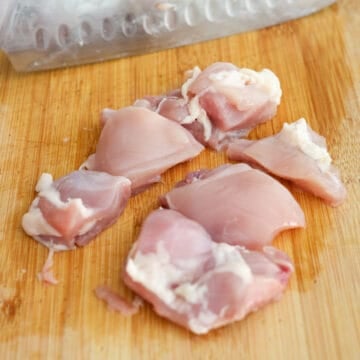 Chicken thighs diced into 1½-inch pieces on a cutting board, still slightly moist