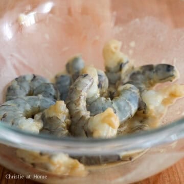 Raw shrimp coated evenly in a light marinade.