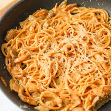Toss in cooked pasta. Lastly, season with black pepper. Mix in grated parmigiano reggiano and garnish with more cheese to enjoy!