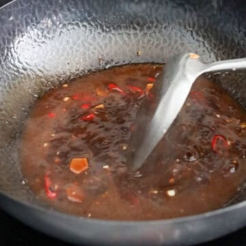 Ginger, garlic, red chilies, and sauce ingredients simmered until thickened.