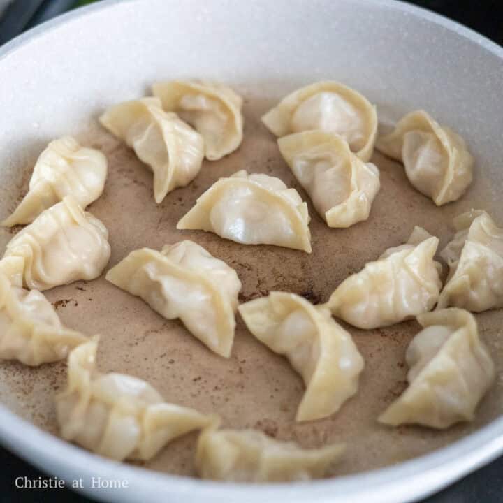 Pan-fried pork and shrimp dumplings with golden brown, crispy bottoms.