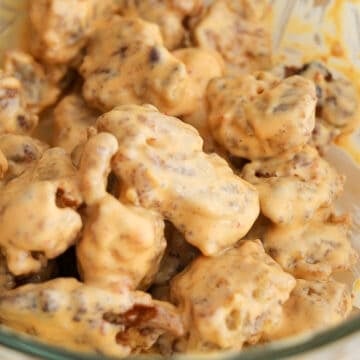 Crispy fried chicken pieces coated in glossy pink sauce.