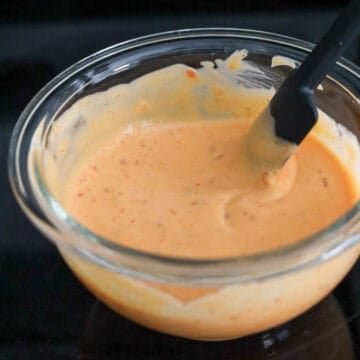 Creamy pink bang bang sauce is mixed in a bowl.
