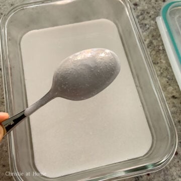 Then scoop ½ cup or 125 ml of the coconut liquid and pour over it over the back of a spoon on top of the firm lychee layer to prevent breaking it. Let this layer set until firm to touch and avoid moving the container. Keep the remaining coconut liquid covered and warm.