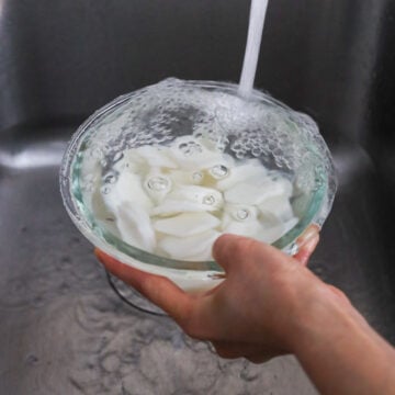 Then rinse rice cakes with cold water a few times to remove any starch. Strain and set aside.